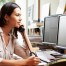 Woman talking on desk phone