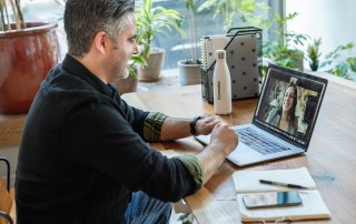 Man having a video conference meeting with colleague on laptop