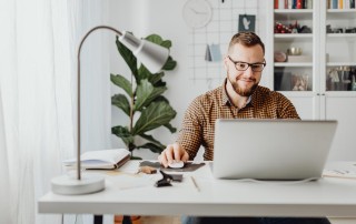 Young male working at home on laptop