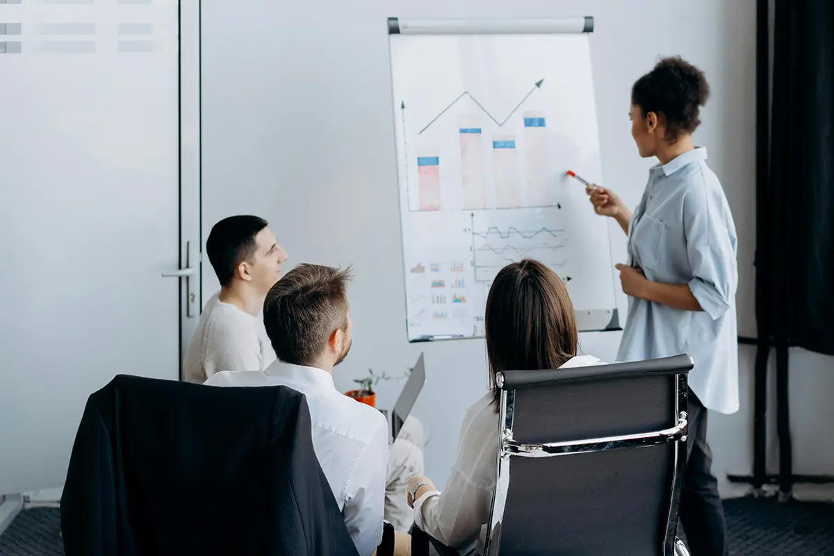 Colleagues gathered around a whiteboard