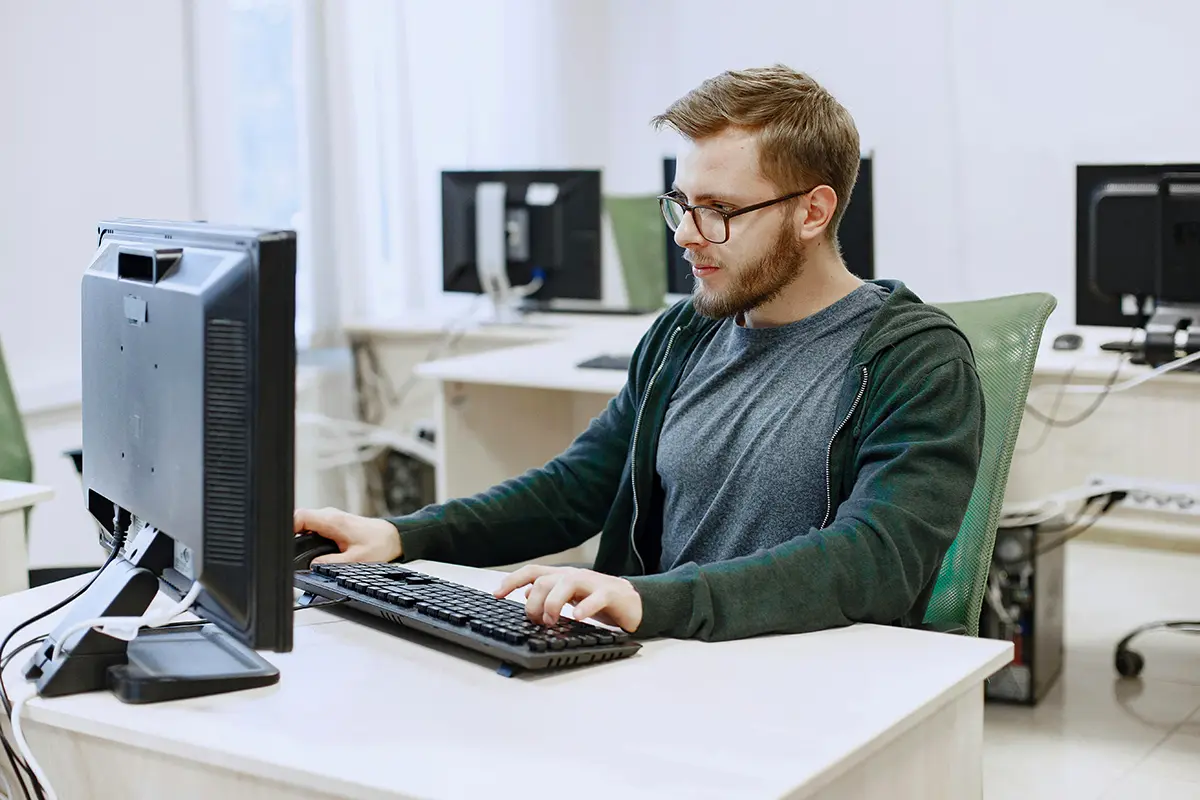 WAN_2 IT worker sat behind PC