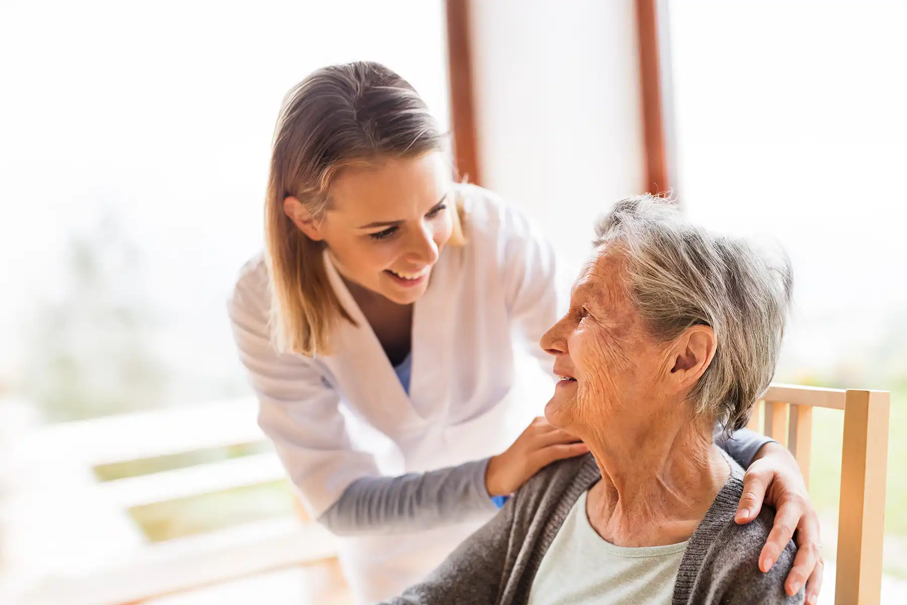 Care worker interacting with elderly woman