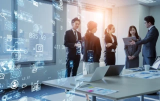 Group of professionals in a modern office discussing business strategy, with digital graphics overlay showing cloud computing, analytics icons, and financial data points.